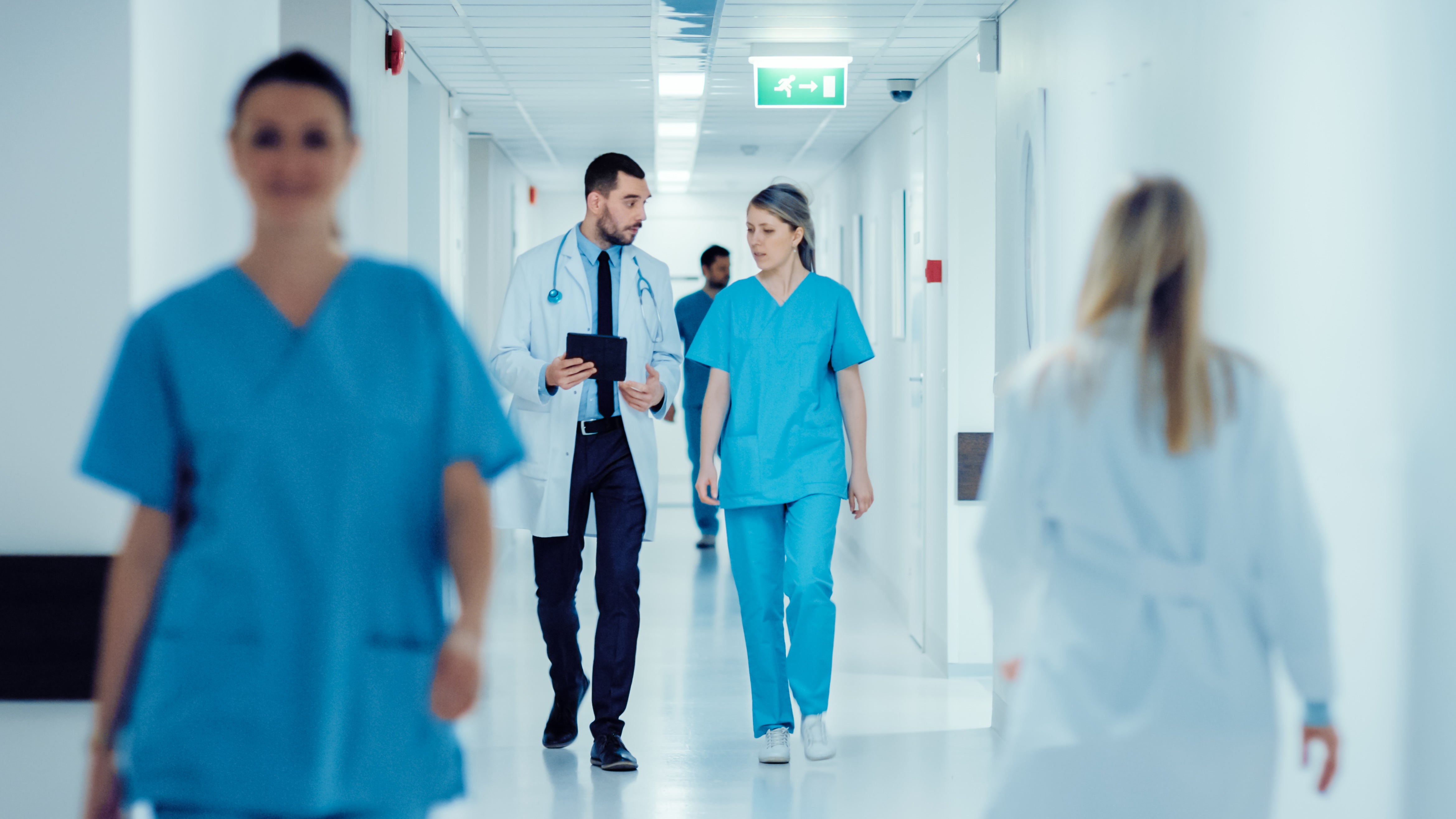 A doctor and a nurse walking